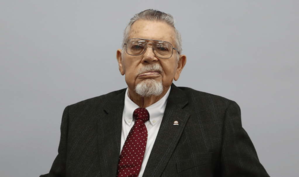 Dr. Johnie Jenkins in a black suit.